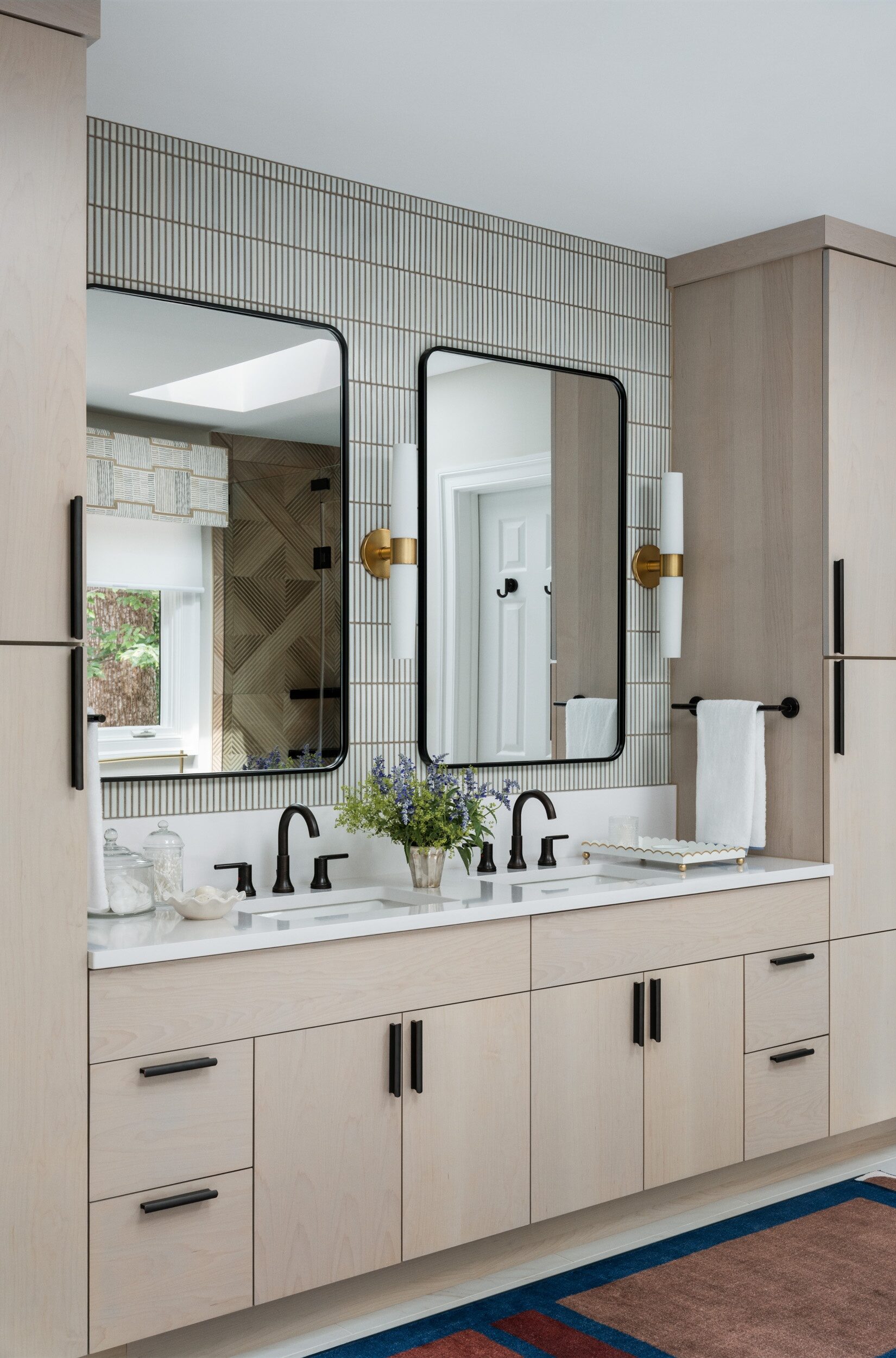 double-vanity-bathroom-light-wood-cabinetry-black-fixtures