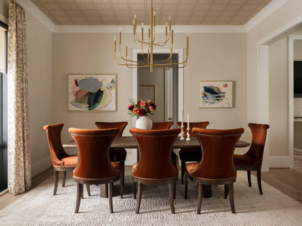 Lp & Co. Dining Room With Wallpapered Ceiling And Orange Chairs